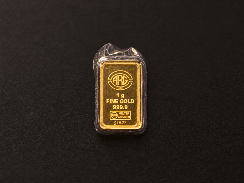 Illustrative small packaged gold bar marked 1 gram